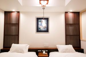 Rúm í herbergi á Kyoto Kamanza Hotel