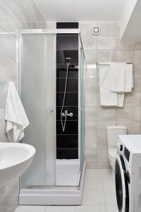 y baño con ducha, aseo y lavamanos. en Moodeight Apartments, en Skopje
