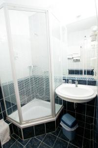 a bathroom with a shower and a sink at Mátyás Király Gyógy- és Wellness Hotel in Hajdúszoboszló