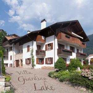 a building with a sign in front of it at VillaGiardino - Lake in Molveno