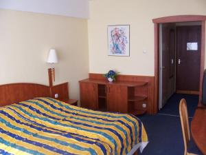 Mátyás Király Gyógy- és Wellness Hotel tesisinde bir odada yatak veya yataklar