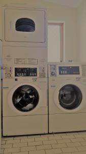 two washing machines sitting next to each other at myOZexp Palmerston Lodge in Perth