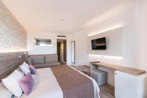 Postel nebo postele na pokoji v ubytování Hotel Na Taconera