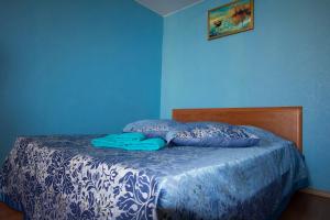 a blue bedroom with a bed with a blue wall at ApartLux Sokolnicheskaya Superior in Moscow