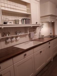 a kitchen with white cabinets and a sink at Haus Resi in Berwang