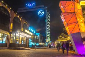 a group of people walking down a city street at night at Summit guest house in Ulaanbaatar