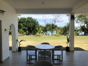 a patio with a table and chairs and a field at Ypsylon Resort Ostküste in Nilaveli