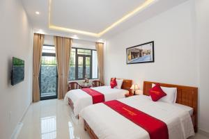 Giường trong phòng chung tại An Bang Golden Beach Villa