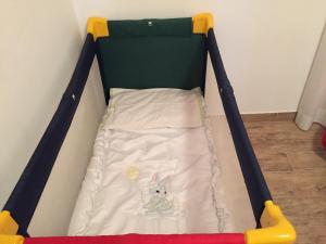 a baby crib with a dog laying in it at Itaka in LʼAquila