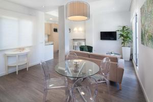 a living room with a couch and a glass table at INM&aacute;laga Penthouse Padilla in M&aacute;laga