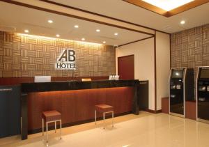 a dc hotel lobby with a reception desk and two stools at AB Hotel Nara in Nara