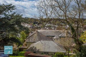a house with a sign in front of it at The Garden Studios in Budleigh Salterton