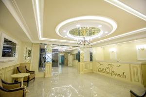 a lobby of a hotel with a chandelier at Golden Beach in Derbent