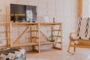 a television on a tv stand in a room at Moll Petit Apartments - Turismo de Interior in Can Picafort