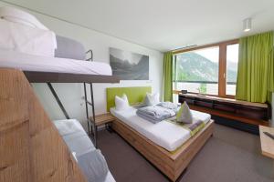 A bed or beds in a room at DORMERO BeHo Zugspitze