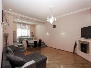 a living room with a couch and a dining room at ApartLux Tverskaya in Moscow