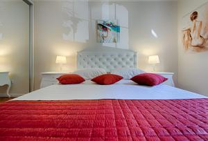 een slaapkamer met een groot bed met rode kussens bij Marella Luxe at the BEACH BACVICE & Split CENTRE in Split