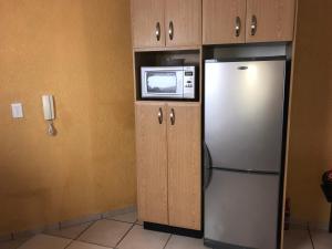 a kitchen with a refrigerator and a microwave at Praslin no 6 in Southbroom