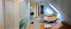 a hallway with couches and chairs in a hospital at Hotel ARTE Schwerin in Schwerin