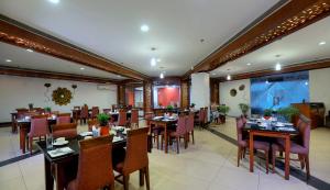 une salle à manger avec des tables et des chaises dans un restaurant dans l'établissement Elevate by TreeHouse, à Bhiwadi