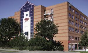 a building with a sign on the side of it at Thon Hotel Triaden in Lorenskog