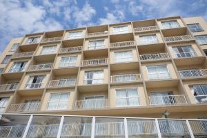 a tall tan building with white windows at Seabrook 210 in Margate