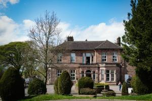 an old brick house with bushes in front of it at Whiston Hall in Whiston +13 photos