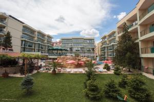 an apartment complex with a large courtyard with a fountain at Sunny Day Club Hotel in Sunny Beach