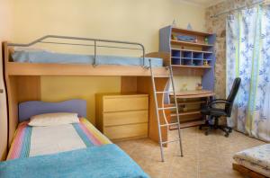 a bedroom with a bunk bed and a desk at Nireas : Stone Villa in Zakynthos
