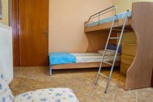 a room with two bunk beds and a ladder at Nireas : Stone Villa in Zakynthos