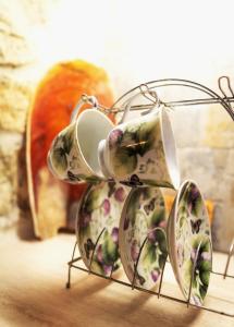 a group of china plates on a rack at Nireas : Stone Villa in Zakynthos