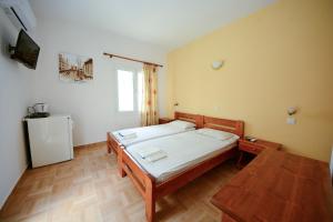 a bedroom with a bed and a television in it at Lampis Studios in Pythagoreio