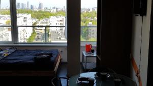 a bedroom with a bed and a large window at Walk distance to mokotow business park in Warsaw