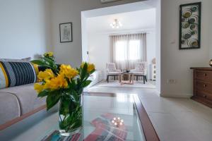 a living room with a vase of flowers on a glass table at Apartments Estrella in Dubrovnik