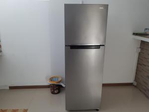a stainless steel refrigerator in a kitchen at Riverside Appartment in La Gaulette