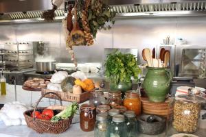 a kitchen with a bunch of vegetables and jars of food at Shepherds Rest Bruton in Bruton