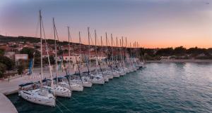 a row of sailboats are lined up in a harbor at Kaleta in Supetar