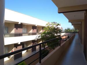 a balcony of an apartment building with people on it at Flex Hotel in Três Lagoas