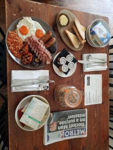 a wooden table topped with plates of food at The Victoria in London