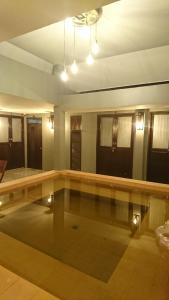 a swimming pool in a living room with lights at Baan Paea Guest House in Ban Ket Ho