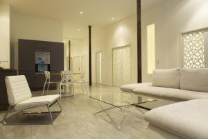 a living room with a couch and a table and chairs at Ausone Beautiful loft apartment in historical center + terrace and parking in Bordeaux