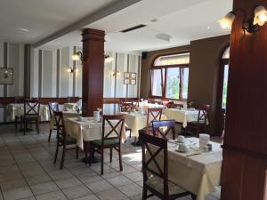 a dining room with white tables and chairs at Villa Belvedere Hotel in Limone sul Garda