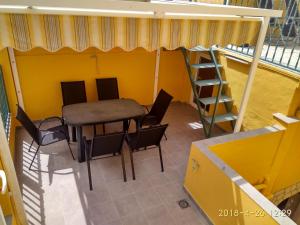 a room with a table and chairs and a ladder at Casa Salamanca in Benidorm +30 photos