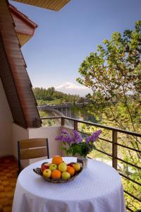 a bowl of fruit on a table on a balcony at Olympia Garden Hotel in Yerevan