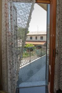 a view of a balcony through a glass door at B&B Mamma Mia Family House in Peschiera del Garda