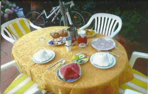 a yellow table with plates of food on it at Primettahouse in San Gimignano