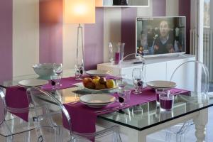 a dining table with a plate of fruit and wine glasses at Residence Le Primule in Stresa