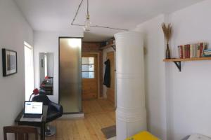 a room with a column and a desk with a laptop at Vintage Design Apartment in Kuldīga
