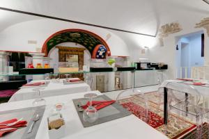 a room with two tables and a kitchen at Il Convento Dei Fiori Di Seta in Bologna