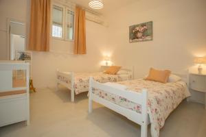 a bedroom with two beds and a window at Summer Bay Apartments in Split